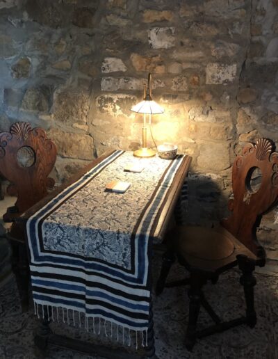 Table and Chairs against a stone wall